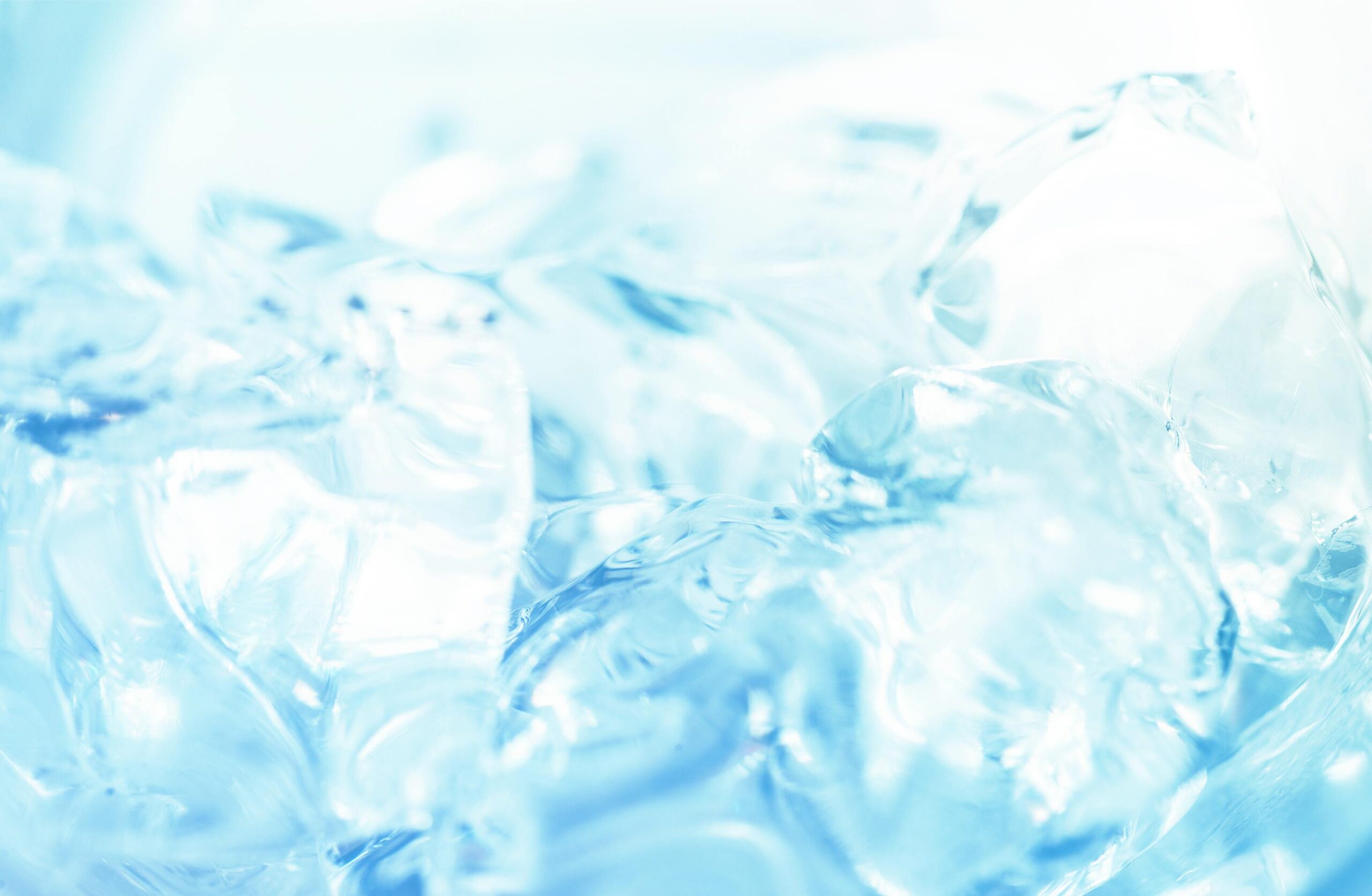 Abstract close-up of ice cubes against a bright blue background, capturing the essence of freshness.